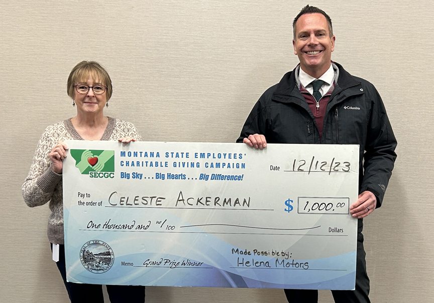 Photo showing Celeste Ackerman, $1,000 Grand Prize winner, and John Way from Helena Motors.